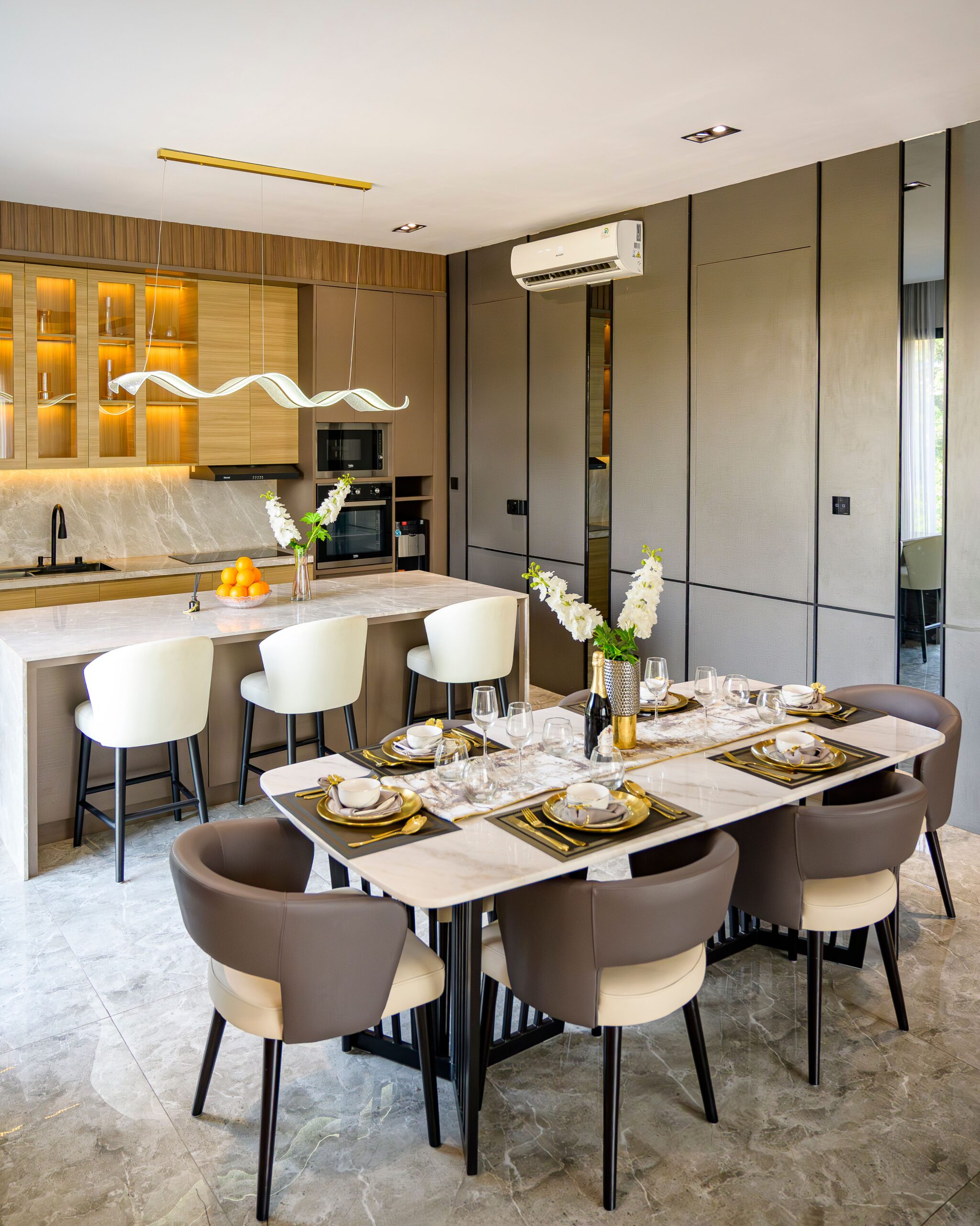 Chic and contemporary dining and kitchen area with elegant decor in Jakarta apartment.